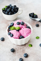 Homemade berry ice cream on a light concrete background.