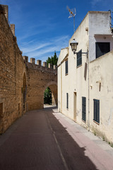 Narrow deserted street in the old medieval town of Alcudia, Mallorca