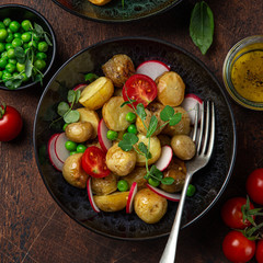 baby potatoes salad with tomato, green peas and radish