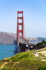 Golden Gate Bridge in the city of San Francisco, California, USA, the most famous and recognizable bridge in the world, a view from an unusual angle in clear sunny weather against a blue sky, one of