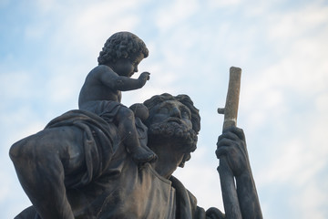 St. Christopher statue on Charles Bridge in Prague, Czech Republic. Medieval Gothic bridge,...