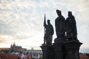 Fototapeta premium Statues of Saints Norbert, Wenceslaus and Sigismund on Charles Bridge in Prague, Czech Republic. Medieval Gothic bridge, finished in the 15th century, crossing the Vltava River