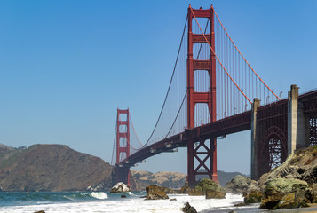 Golden Gate Bridge in the city of San Francisco, California, USA, the most famous and recognizable bridge in the world, a view from an unusual angle in clear sunny weather against a blue sky, one of