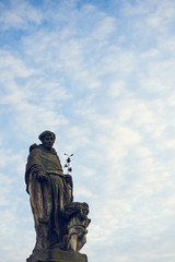 St. Nicholas of Tolentino statue on Charles Bridge in Prague, Czech Republic. Medieval Gothic bridge, finished in the 15th century, crossing the Vltava River