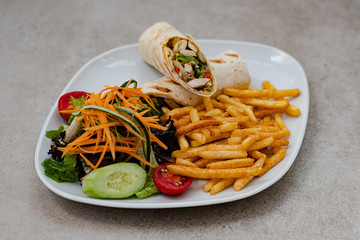 Serviced Wrap with potato and salad in plate