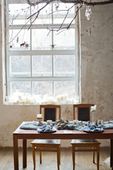 table setting with candles and blue tissue