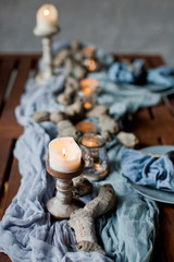 table setting with candles and blue tissue