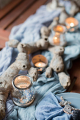 table setting with candles and blue tissue