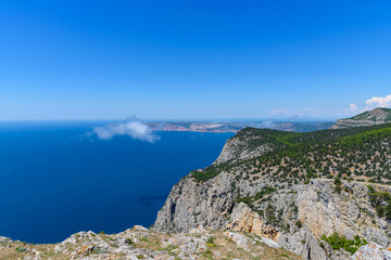 view of the Black Sea from the height of Mount Ayia, a cape on the southern coast of the Crimea, to the south-east of Balaclava. Sunny bright day with clouds on the sky. Spring view of the Crimea.