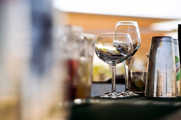 Empty wine glasses on the bar.