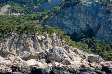 cliff shore from the side of a pleasure boat in the black sea, on a sunny day.