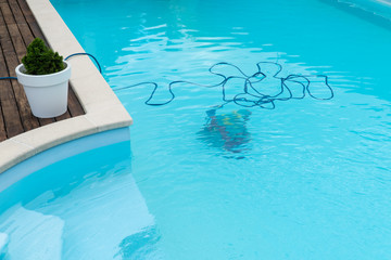 Fototapeta na wymiar Robot cleaning swimming pool