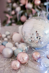 christmas background with candles, silver balls, blue garland and disco ball