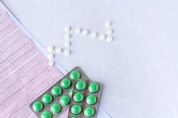 Cardiogram with a pills, tablets on a background