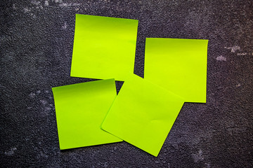 Self-adhesive paper, notes. Top view on a black background, close-up.