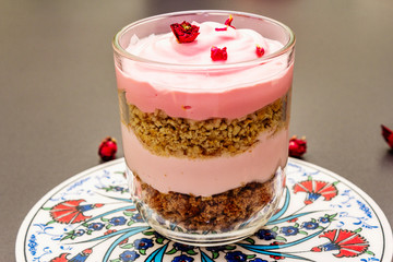 Delicate cream dessert. Traditional turkish edible rose, flower petals