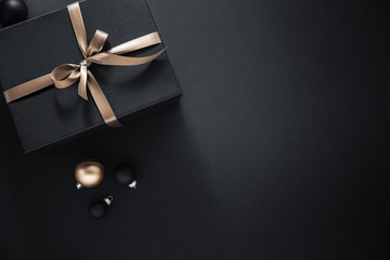 Gift wrapped in dark paper on dark background