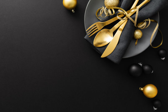 Gold Cutlery Served On Plate For Christmas Dinner