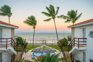 Fototapeta na wymiar Ilha de Itamaraca, Brazil - Circa August 2019: Sunset view from a fancy condominium by the beach on Itamaraca Island (Pernambuco state)