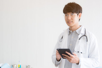 Young Asian young doctors are standing smiling and caring for patients. Medical concepts