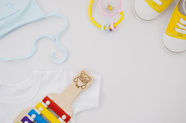 Flat lay baby clothes with xylophone