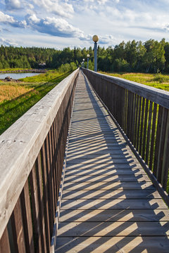 Wooden foot bridge over the Pite River in Storforsen nature reserve in Swedish Lapland.