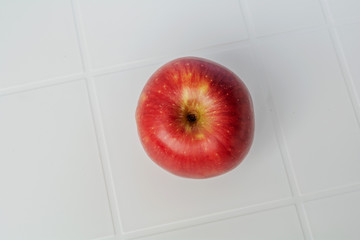 Red apple isolated on the white table. With clipping path.