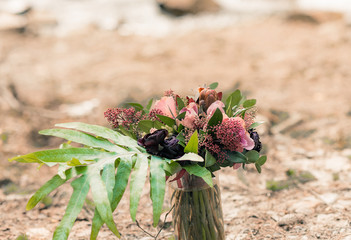 Bridal bouquet with red and pose colors on the stone