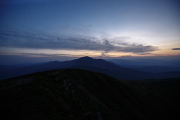 sunset in the mountains line of blue beautiful mountains