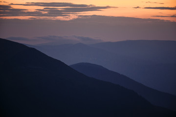 sunset in the mountains line of blue beautiful mountains