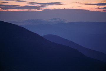 sunset in the mountains line of blue beautiful mountains