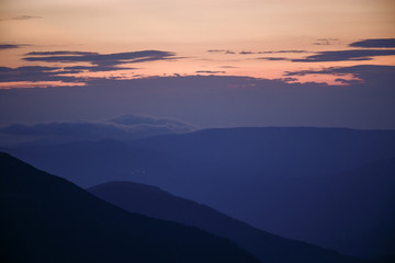 Fototapeta premium sunset in the mountains line of blue beautiful mountains