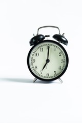 Black alarm clock isolated on white