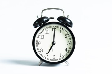 Black alarm clock isolated on white