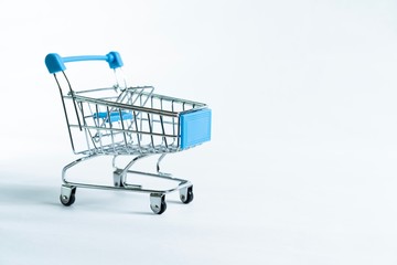 Mini shopping trolley isolated against white background