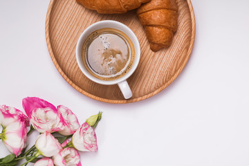 Coffee, croissants and flowers on the white background,