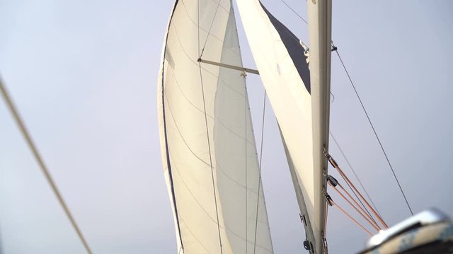 Mast with a white sail on a yacht in the Black Sea