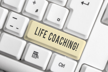 Handwriting text Life Coaching. Conceptual photo demonstrating employed to help showing attain their goals in career White pc keyboard with empty note paper above white background key copy space