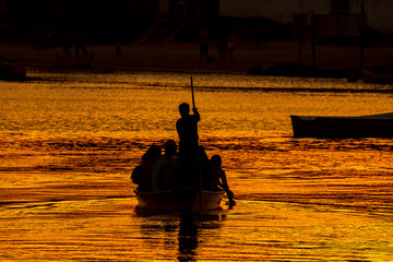 Canoe crossing Rio da Madre during sunset in Guarda do Embaú - Santa Catarina Brazil