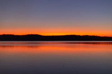 Fototapeta na wymiar Lake sunset silhouette. Finnish lake landscape photo.