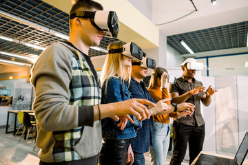 Team of developers working with virtual reality glasses during a business meeting. Young business...