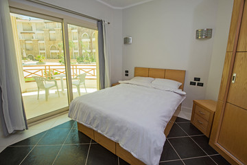 Interior design of bedroom in tropical resort apartment