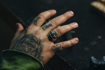 Close up of jeweler hand with scull shape ring