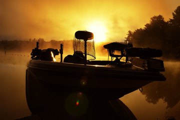 Fishing boat with dawn fishing equipment in the fog on a forest lake. fishing in the USA. maine. USA.