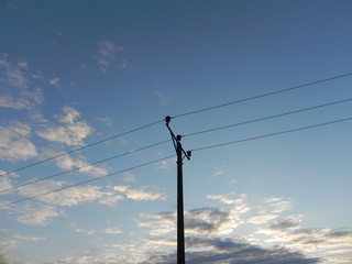 Electric pole in a cloudy sky