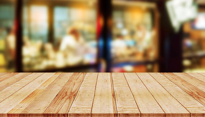 Empty wooden table with abstract blurred background of coffee shop