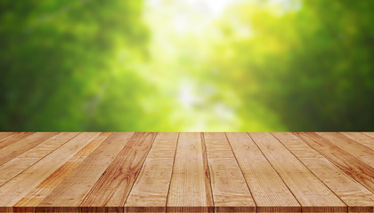 Empty wooden table with blur of green nature background