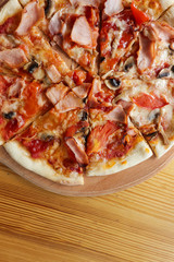 Tasty hot pizza on wooden table
