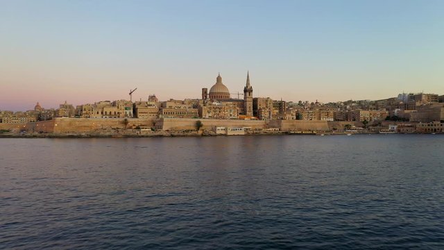 Aerial view of Valletta city. Malta. Evening, dusk, sunset time. Camera forward and up