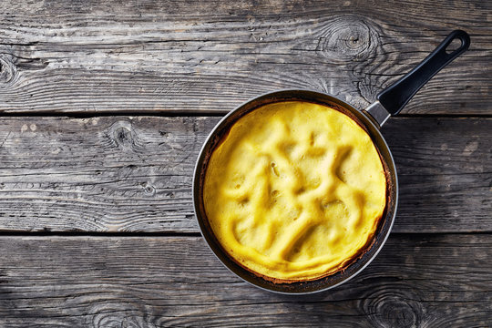 classic omelet, a dish of beaten eggs